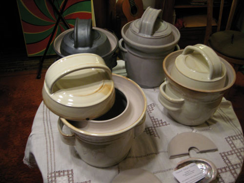 Handmade crocks by Sarah Kersten, of Berkeley, California, are made in the style of the famous German Harsch crocks with moats that fill with water to create a water lock and prevent fresh air from entering the fermentation chamber. These crocks come with semi-circular weights to keep contents submerged.